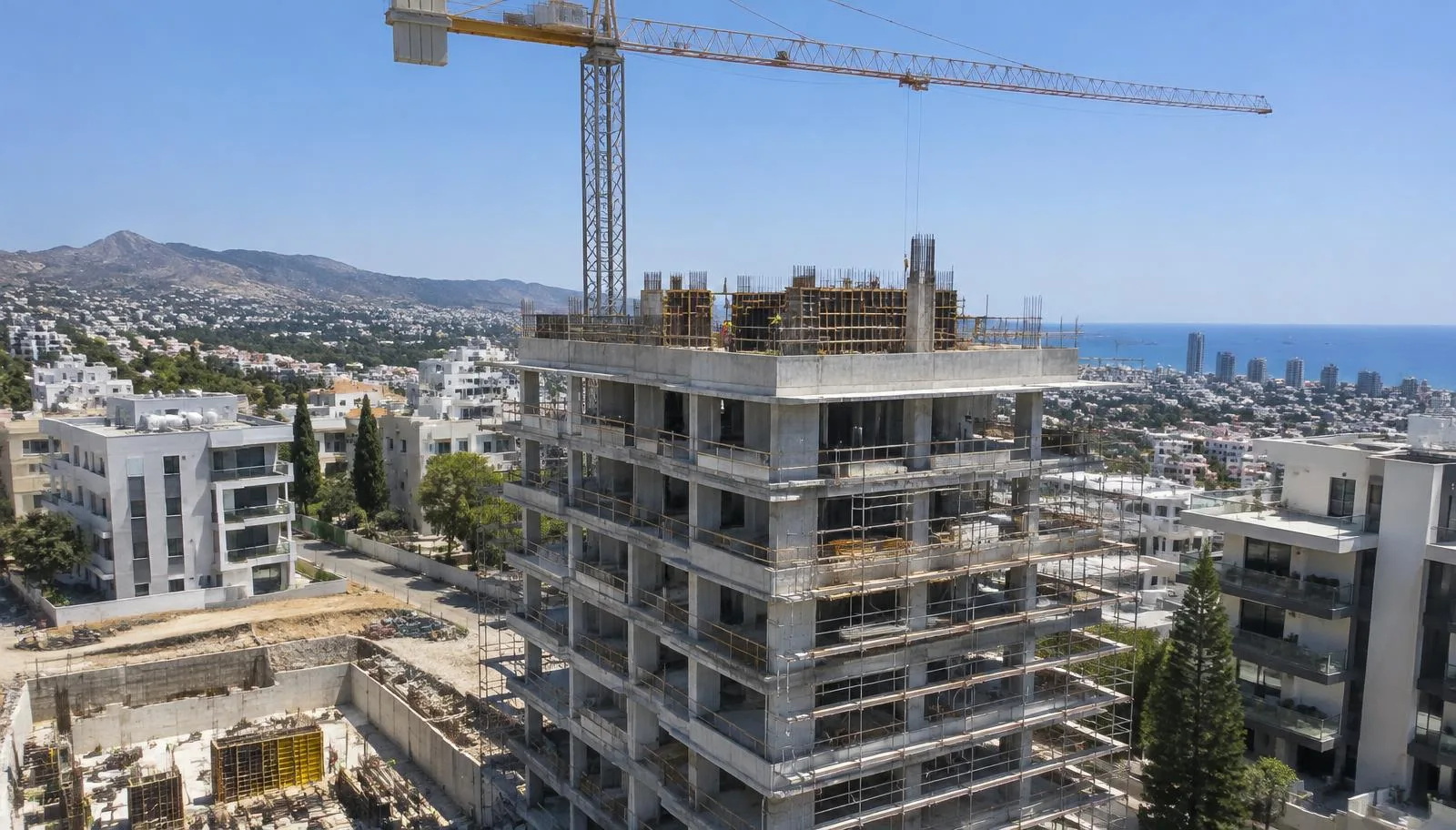 Apartment building under construction in Limassol with the sea behind